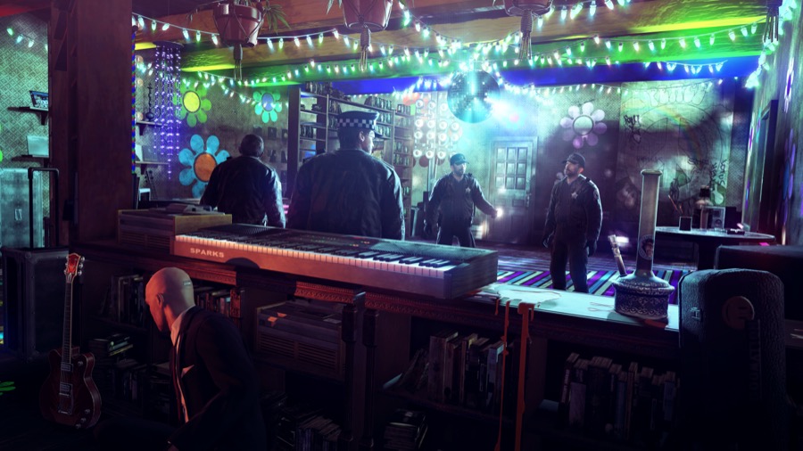 Agent 47 is hiding behind a mixing desk whilst Police Officers dance under a disco ball.