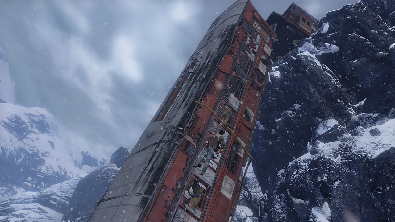 A train hangs over a cliff in a snowy mountain