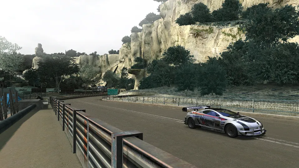 A race car on a track in a beautiful location